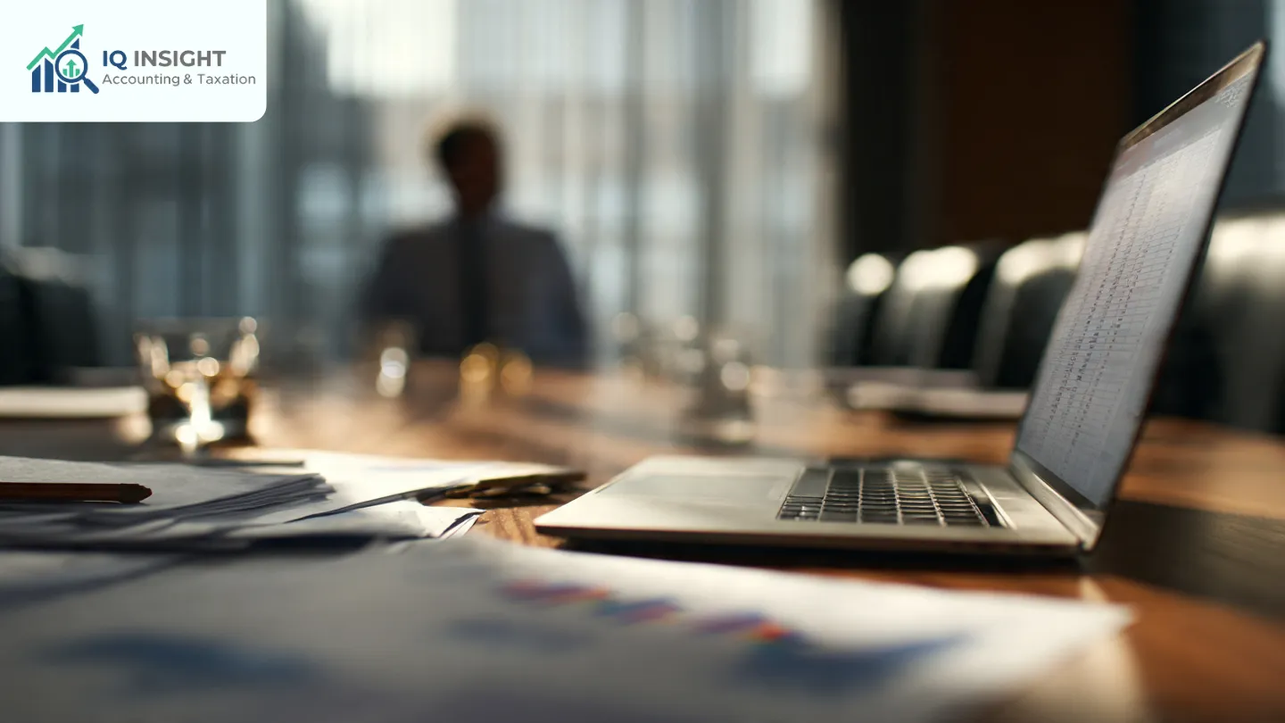 Laptop and financial reports on a boardroom table for outsourced CFO services.