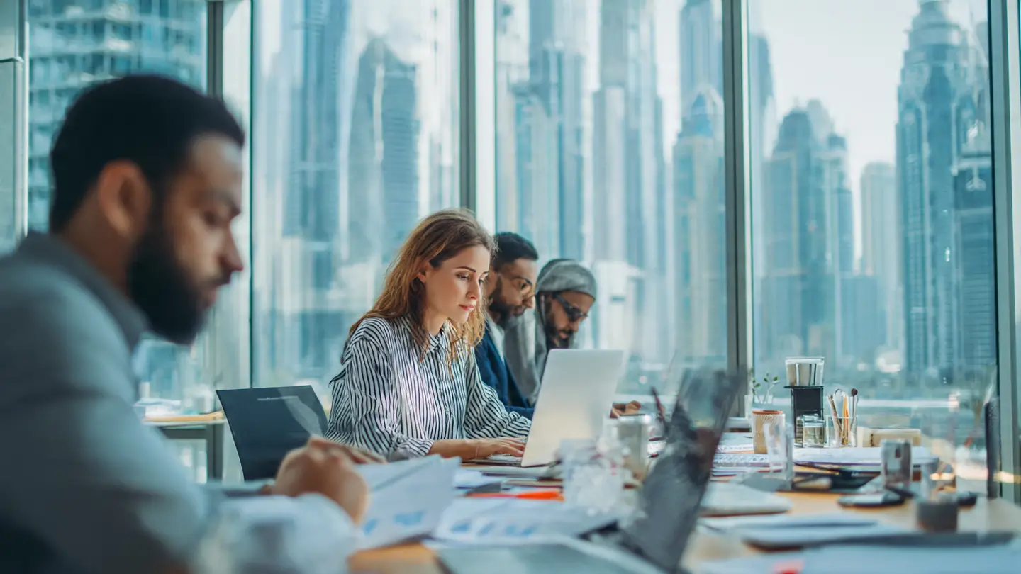 Team discussing how payroll errors impact business operations during a meeting in the UAE.